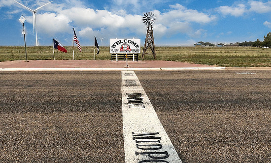 Painted line across Route 66 in Adrian, Texas marking the midpoint of the historic highway