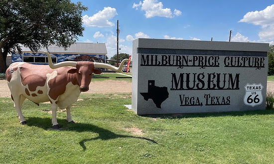 Sign and exterior view of the Milburn-Price Culture Museum in Vega, Texas, on Historic Route 66